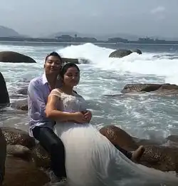 一对胖胖的情侣在海边拍婚纱照,新郎拥抱的姿势像抱了一只母猪
